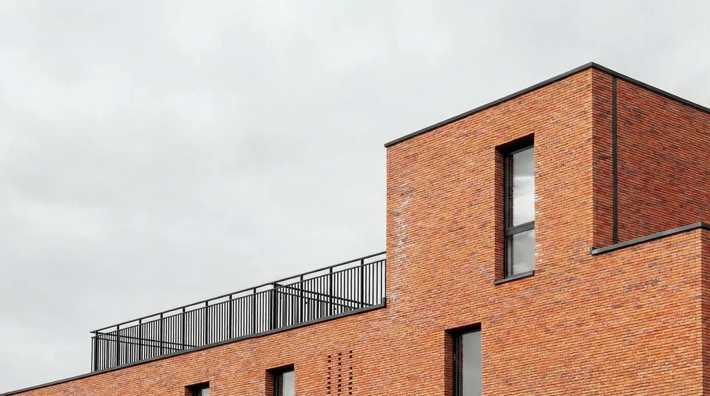 Bâtiment contemporain en briques rouges, vue extérieure en contre-plongée